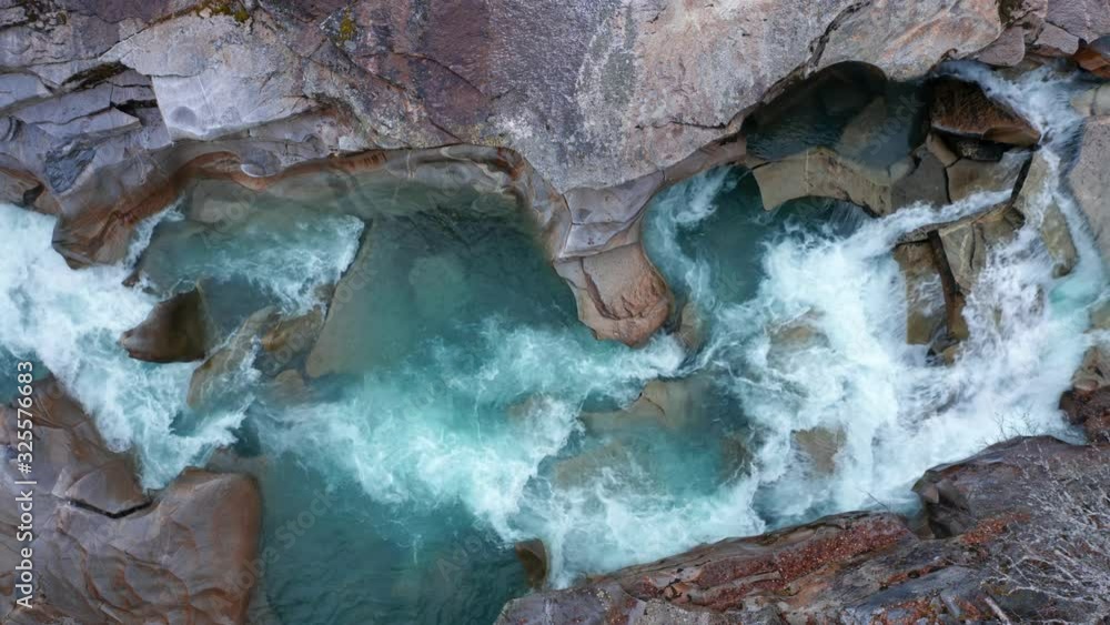 The turbid waters of Storelva river rushing on rapidly below, in the channel carved in stone over the centuries. The turbid waters of Storelva river rushing on rapidly below, in the channel carved in stone over the centuries.