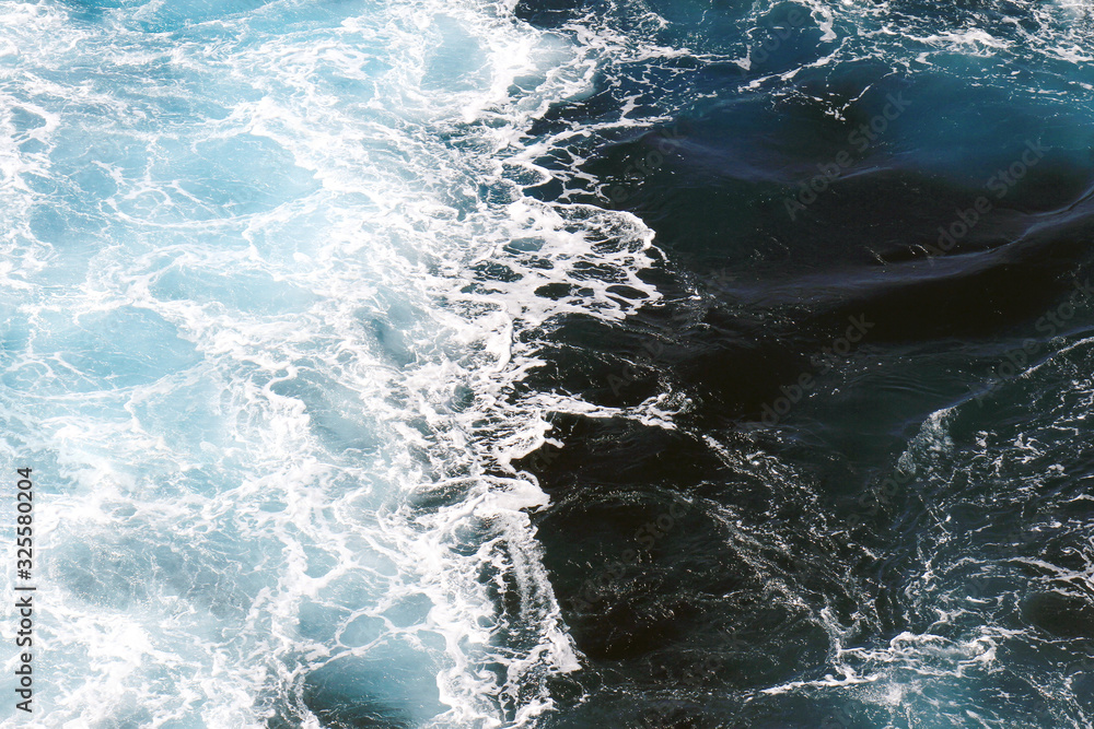 Ocean waves wallpaper, Dark blue water and sea foam from aerial view, Natural abstract pattern background with copy space for web banner and design template. Ocean waves wallpaper, Dark blue water and sea foam from aerial view, Natural abstract pattern background with copy space for web banner and design template.
