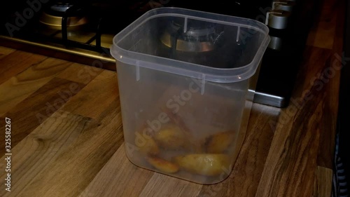 Preparing a lunchbox for work with fryied potatoe quarters. Food for work concept. photo
