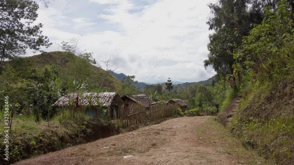 Entering a traditional village in the mountains of Papua New Guinea. Entering a traditional village in the mountains of Papua New Guinea.
