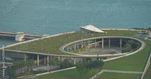 Local people relaxing with their friends and family in the park built on top of Marina Barrage to enjoy the view of Singapore Skyline in daytime