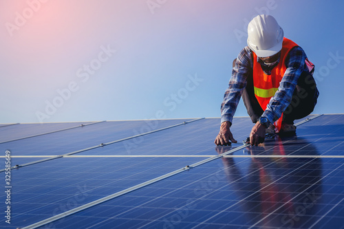Electrical, instrument technician use wrench for fix and maintenance electrical system at solar panel field photo
