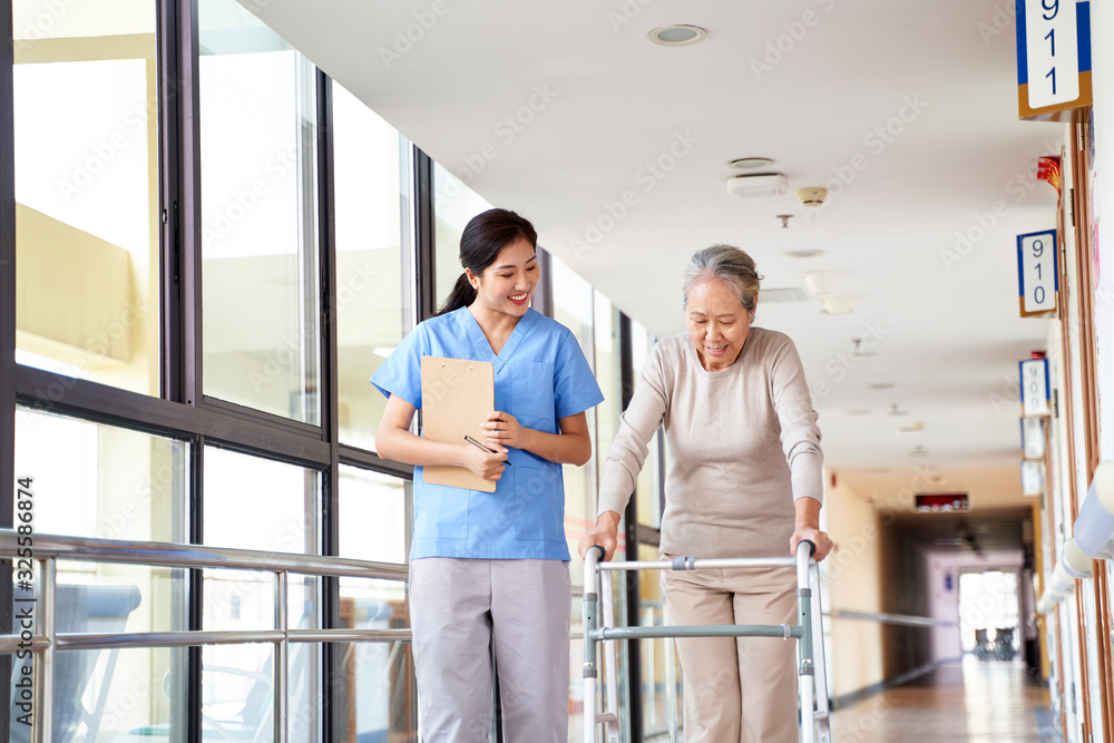 asian old woman walking with a walker in rehab center asian old woman walking with a walker in rehab center