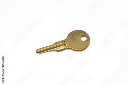 A brass cam lock key, close up, isolated on a clean, white background.  Shot in macro. © Peter