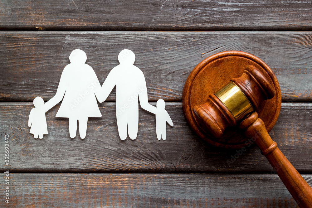 Divorce court concept. Judge gavel near family on dark wooden background top-down Divorce court concept. Judge gavel near family on dark wooden background top-down