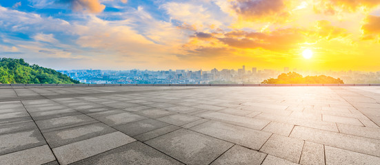 Wide square floor and city skyline at sunrise in Hangzhou,China.