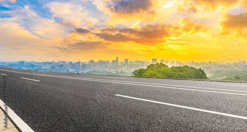 Empty asphalt road and city skyline at sunrise in Hangzhou,China.