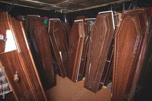 Valokuvatapetti Wooden coffins in the dark room.