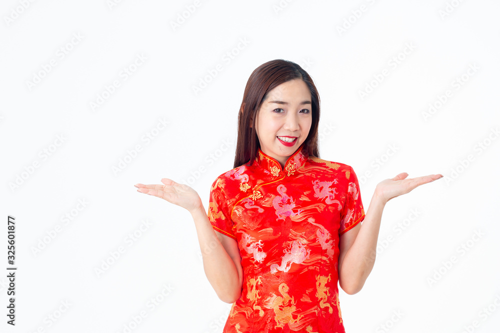 Asian woman in chinese dress traditional cheongsam. The woman raised both hands and thought about which item to choose. Asian woman in chinese dress traditional cheongsam. The woman raised both hands and thought about which item to choose.