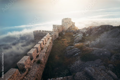 Canvas Print Medieval fortress, wall and tower landscape with cloudy sky.