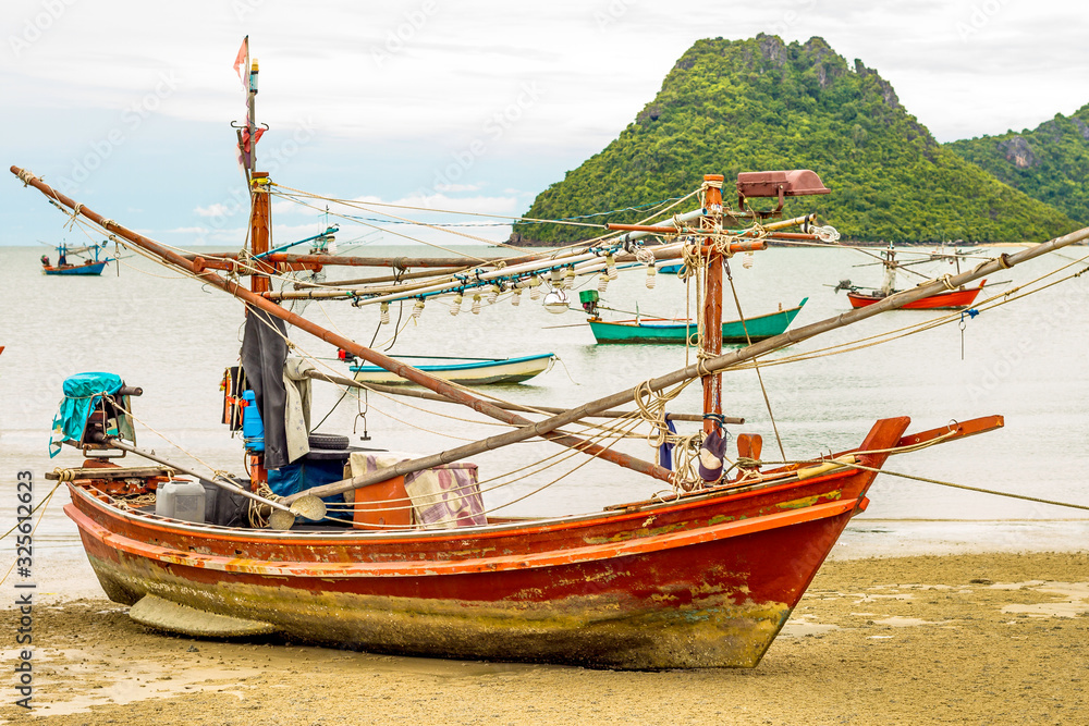 Fishing boat on the beach. Fishermen is a career that has been popular in the seaside city of Thailand.