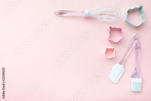Mix backing utensils on pink background, top view, copy space