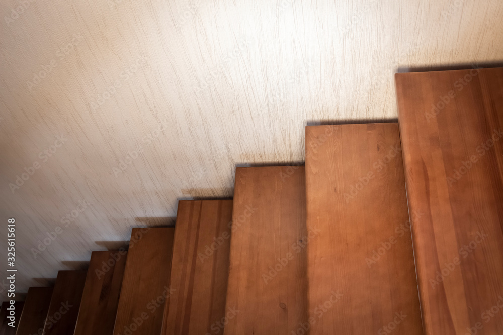 Fragment of a wooden interior staircase in a private house. Fragment of a wooden interior staircase in a private house.