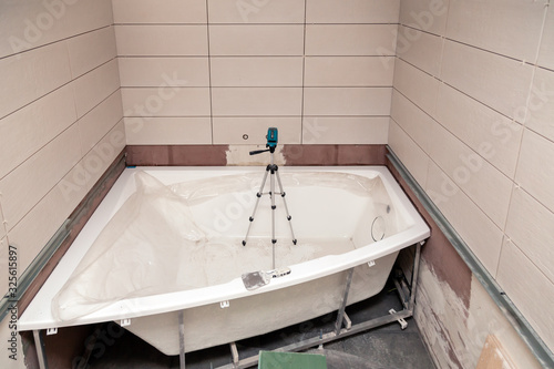 Bathroom interior repair, laying tiles on walls
