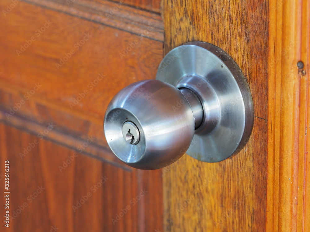 A picture of Door knob that was installed on a wooden door A picture of Door knob that was installed on a wooden door