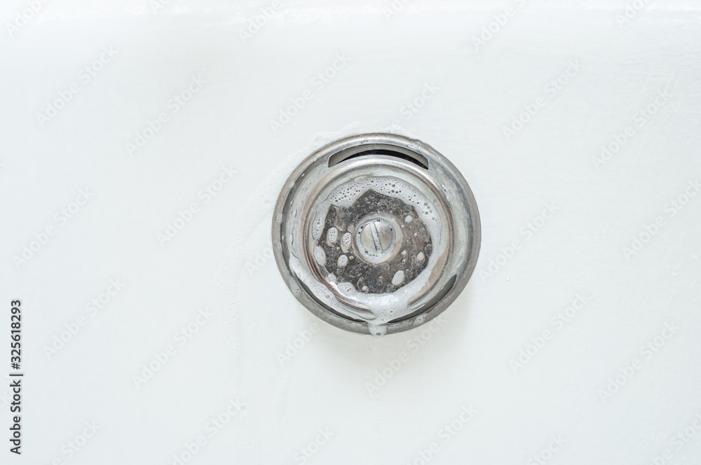 Lathering an iron element in the bathroom with thick foam Lathering an iron element in the bathroom with thick foam