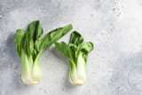 Two Fresh green baby Pak choi (chinese cabbage) on white background. Fresh, green vegetable, close-up shot. Healthy lifestyle theme, kitchen scene. Copy space. Minimalism concept for design.
