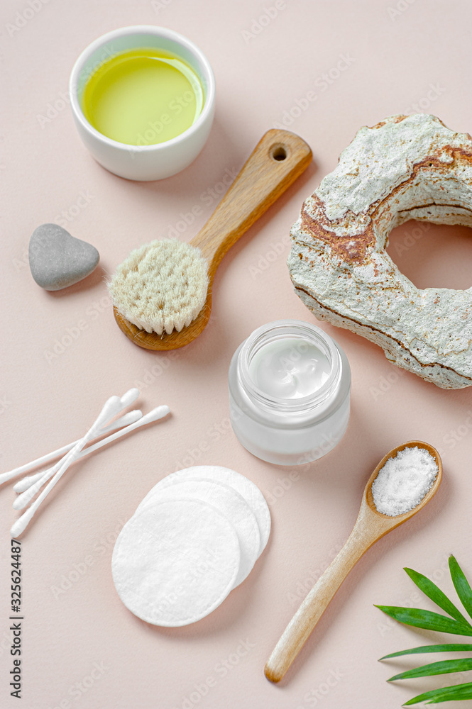Accessories, cream and natural cosmetics for body care on a light pink background. Accessories, cream and natural cosmetics for body care on a light pink background.
