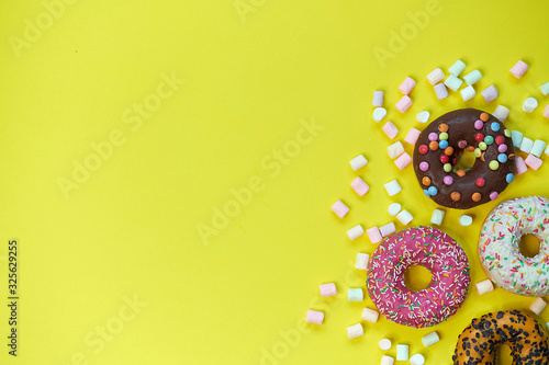 donut and marshmallow on a yellow background. top view photo © yavdat
