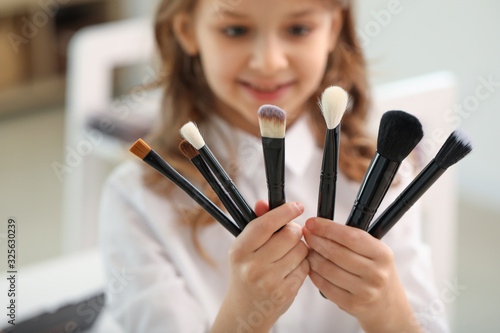 Cute little makeup artist at home