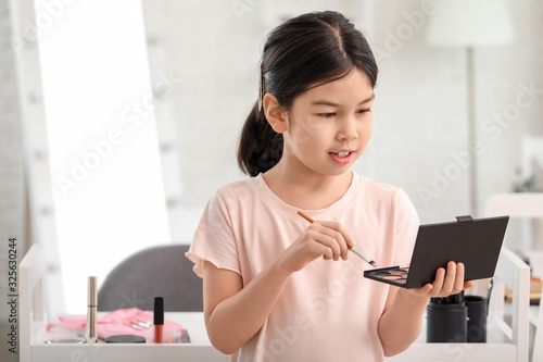 Cute little makeup artist a...