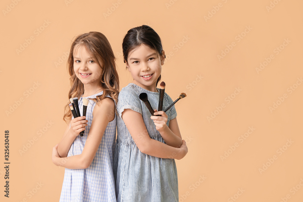 Cute little makeup artists on color background Cute little makeup artists on color background