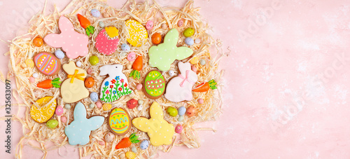 Colorful Easter homemade gingerbread cookies in shape of eggs and bunny and candy. Easter baking concept.