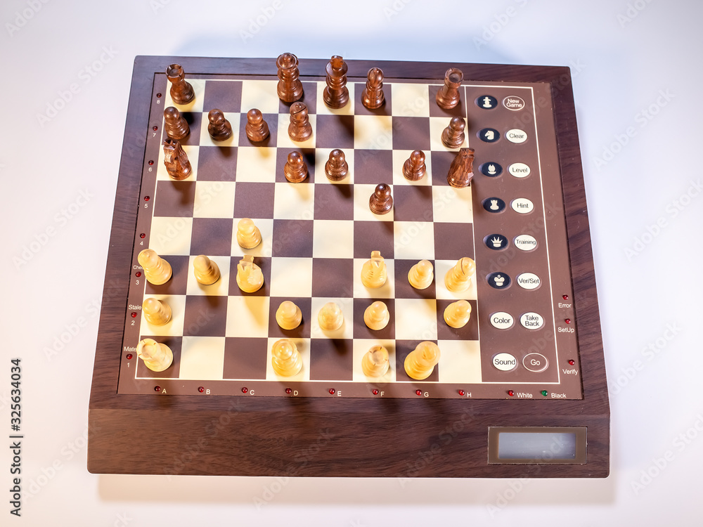 Top down view of chess pieces on an electronic chessboard on a white background Top down view of chess pieces on an electronic chessboard on a white background