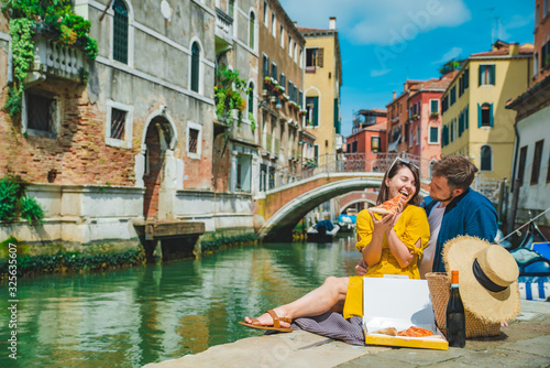 couple having date at pier with beautiful view of venice canal