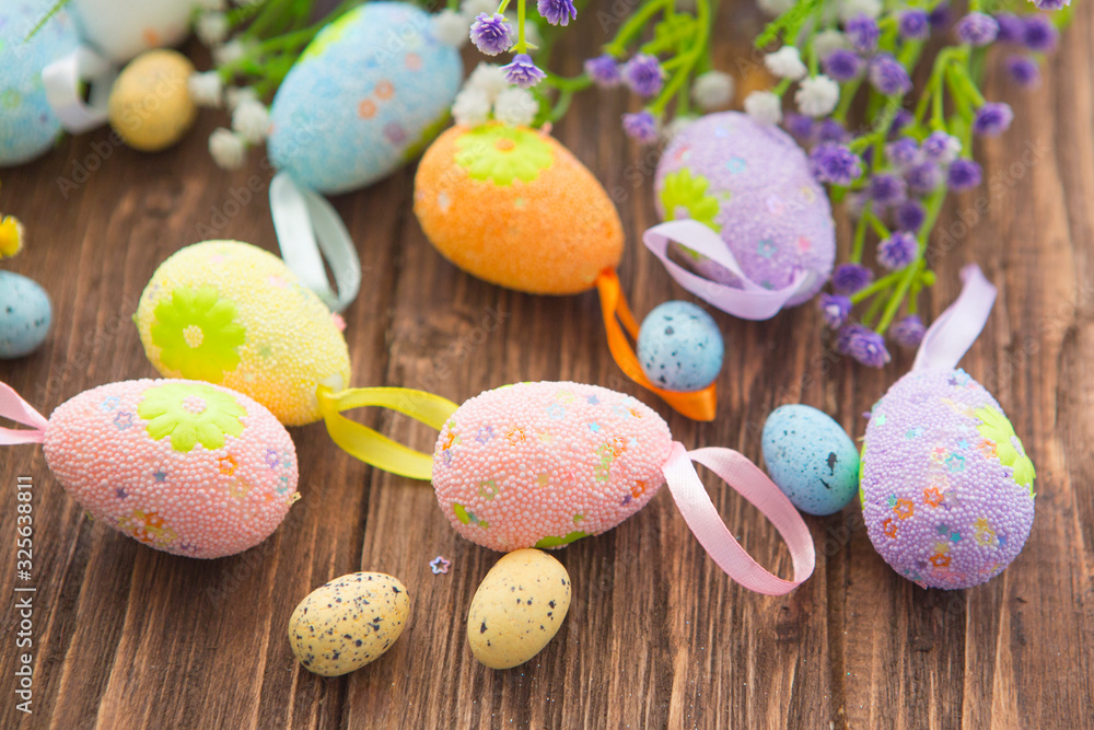 Easter eggs and spring flower on rustic wooden background.