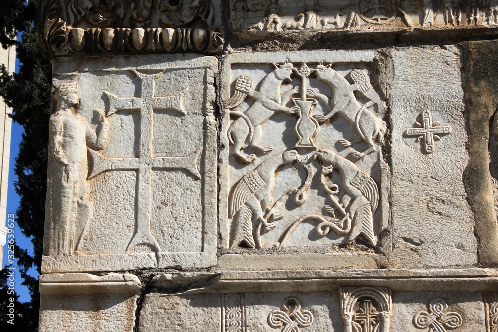 Carved stones decorate the exterior wall of an old Christian orthodox church in Athens, Greece