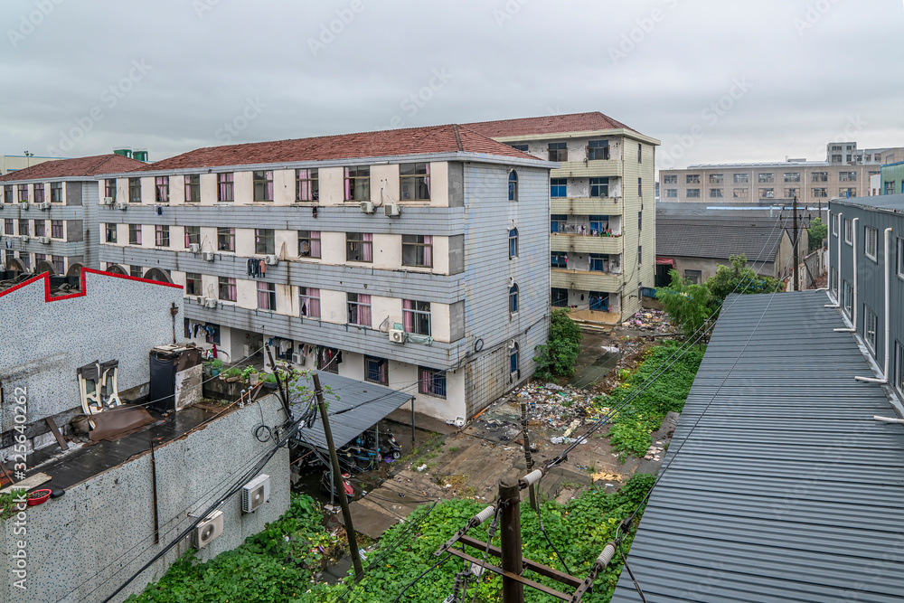 Apartment building and garbage dump in small industrial city in China