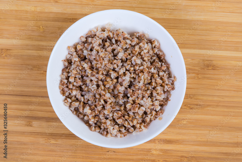 Top view of buckwheat porridge in the white bowl Top view of buckwheat porridge in the white bowl