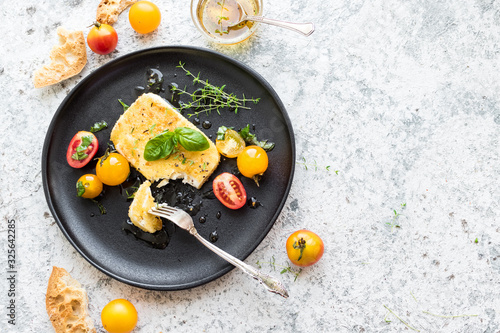 Pan-fried salty feta cheese coated in breadcrumbs photo