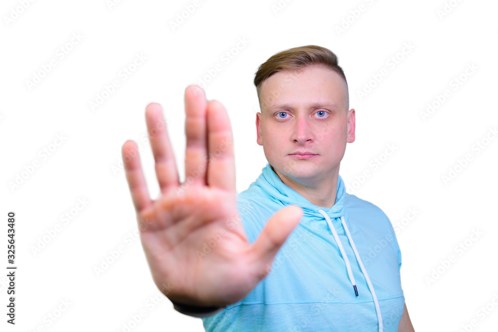 portrait of a cheerful young guy with his palm shows STOP. isolated on white background portrait of a cheerful young guy with his palm shows STOP. isolated on white background