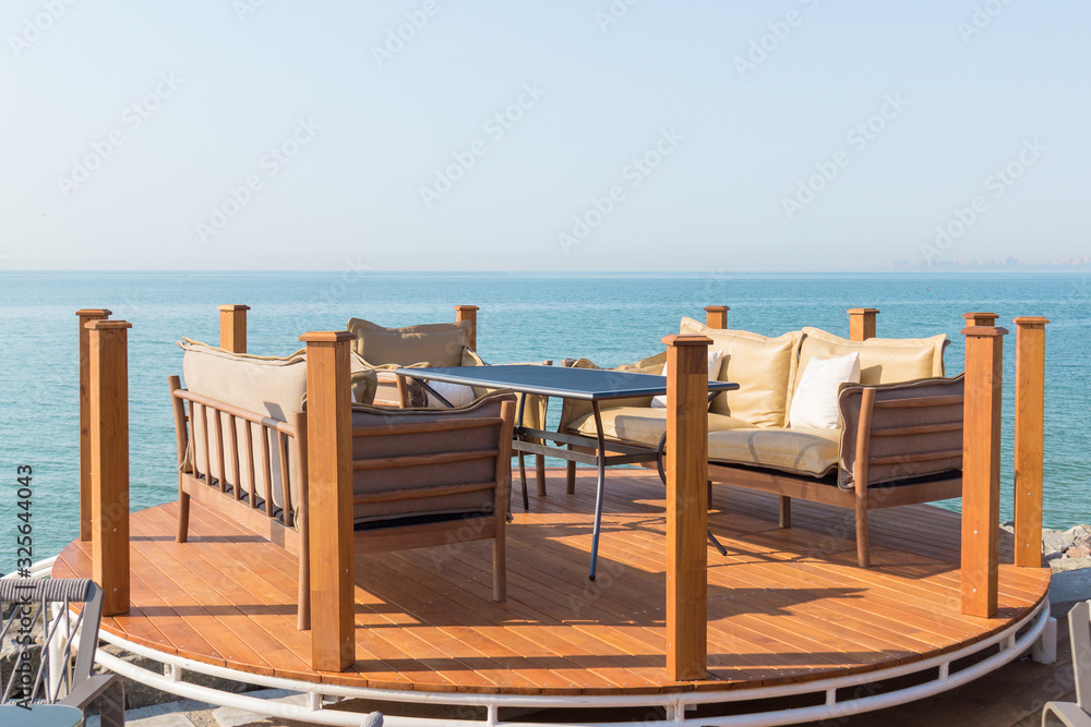 Beautiful terrace with table, sofas and armchair. Great sea view