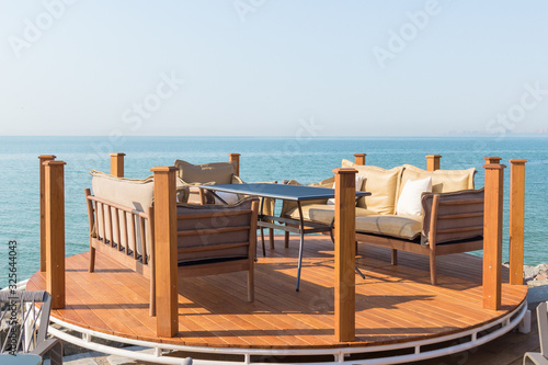Beautiful terrace with table, sofas and armchair. Great sea view