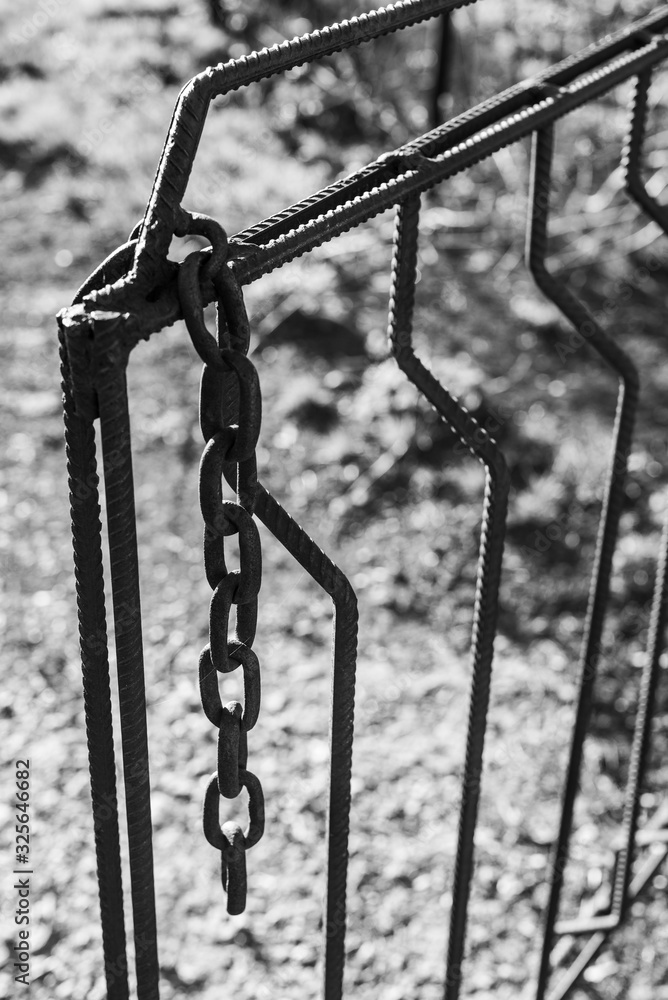 Old rusty metal chain hanging on a gate. Closeup