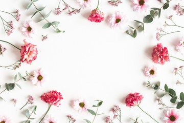 Flowers composition. Frame made of pink flowers and eucalyptus branches on white background. Valentines day, mothers day, womens day concept. Flat lay, top view