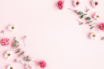 Flowers composition. Pink flowers and eucalyptus branches on pink background. Valentines day, mothers day, womens day concept. Flat lay, top view