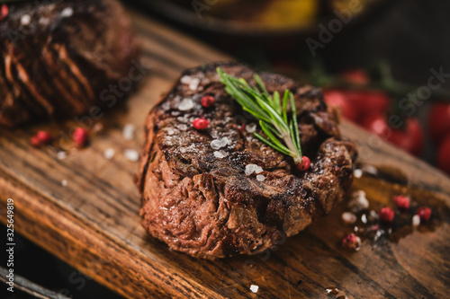 Fototapet Grilled fillet steaks on wooden cutting board