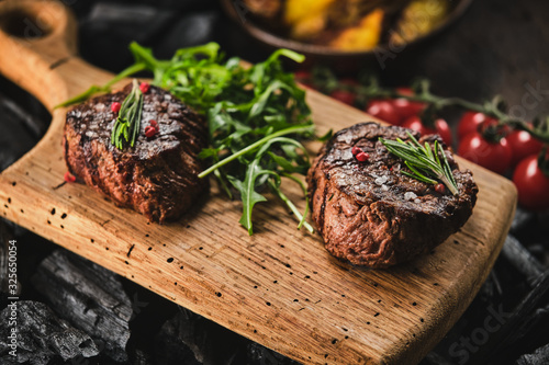 Stampa su tela Grilled fillet steaks on wooden cutting board