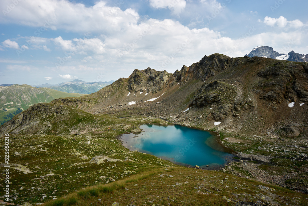 Alpine turquoise lake of Sofia, surrounded by rocks. Karachay-Cherkessia, Arkhyz. Russia