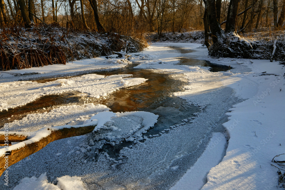 forest river in ice in early spring