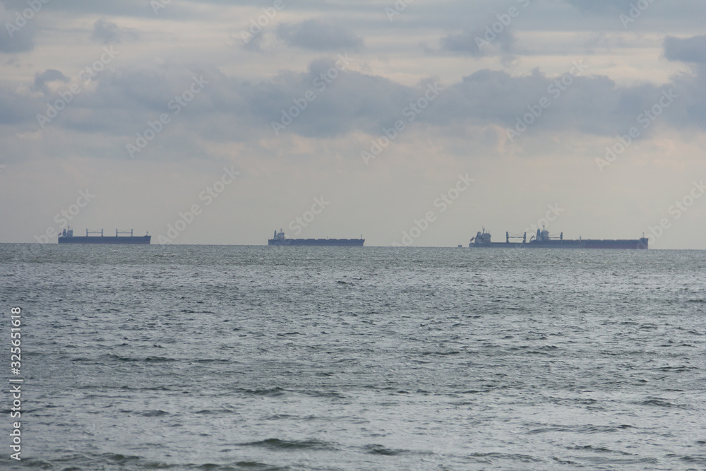 tanker, barge on the horizon, in the ocean bay