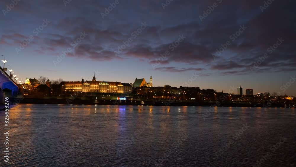 River view panning of Warsaw Old Town at evening twilight, capital city of Poland, illuminated bridge and the Royal Castle River view panning of Warsaw Old Town at evening twilight, capital city of Poland, illuminated bridge and the Royal Castle