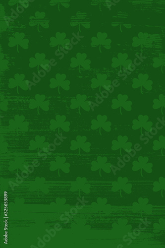 Grunge pattern with signs of shamrocks. Vertical green shade backgrop.