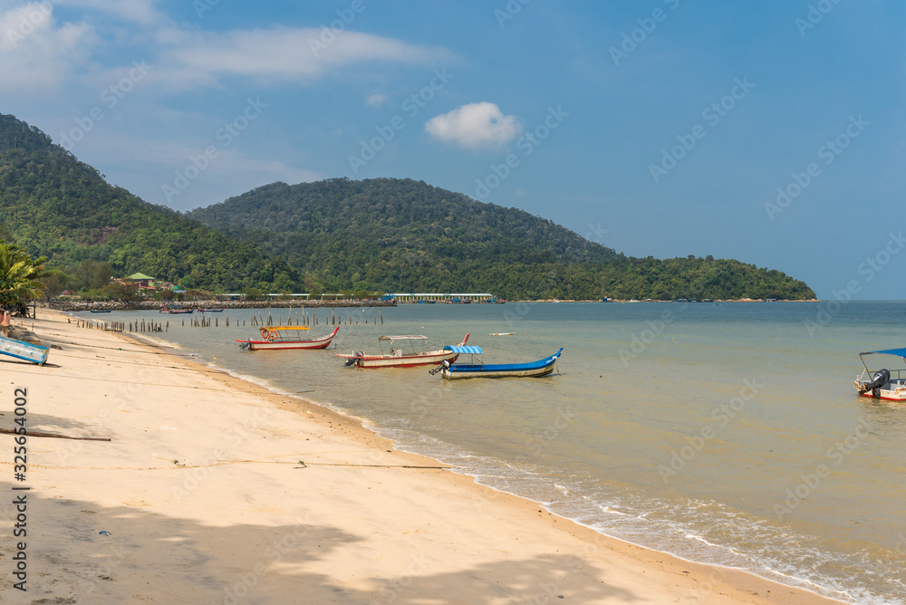 Fishing boats moored in the sea and at the beach of the fishing village Teluk Bahang in the north of the island of Penang