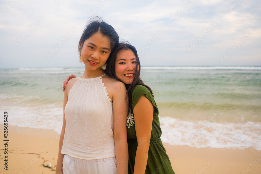 young beautiful and happy couple of attractive Asian Korean women walking together relaxed at the beach enjoying holidays having fun feeling free and joyful young beautiful and happy couple of attractive Asian Korean women walking together relaxed at the beach enjoying holidays having fun feeling free and joyful