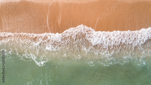 Top down view landscape scene of waves crashing on empty tropical beach